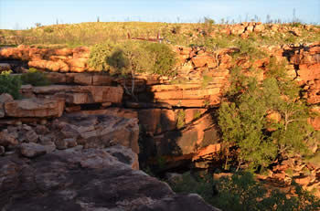 Helicopter waiting on top of the waterfall which was its landing pad